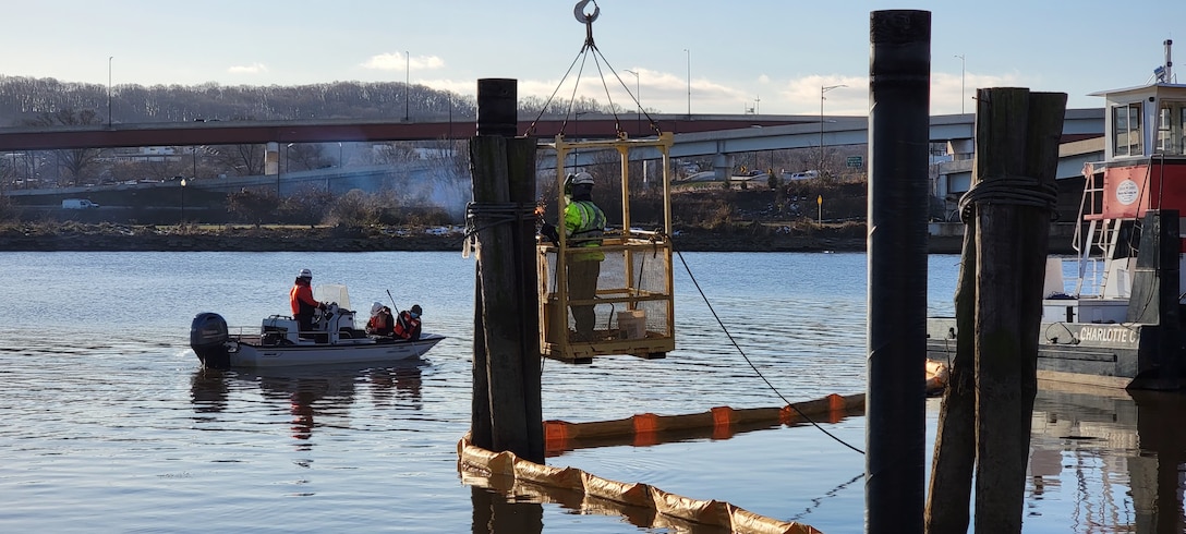 U.S. Army Corps of Engineers, Baltimore District, biologists conduct water turbidity testing while local contractors perform construction modifications on the District’s DC Drift field office dock’s alongside the Anacostia River in the District of Columbia, Jan. 13, 2022. The District’s DC Drift field office manages a portion of the river’s debris removal efforts, spanning 27-miles long with an area of approximately 16 square miles. USACE boat operators conduct routine debris patrols and respond to debris calls from the U.S. Coast Guard, U.S. Navy, boat and marina operators, and private citizens. (Courtesy photo)