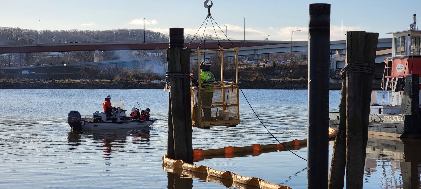 U.S. Army Corps of Engineers, Baltimore District, biologists conduct water turbidity testing while local contractors perform construction modifications on the District’s DC Drift field office dock’s alongside the Anacostia River in the District of Columbia, Jan. 13, 2022. The District’s DC Drift field office manages a portion of the river’s debris removal efforts, spanning 27-miles long with an area of approximately 16 square miles. USACE boat operators conduct routine debris patrols and respond to debris calls from the U.S. Coast Guard, U.S. Navy, boat and marina operators, and private citizens. (Courtesy photo)