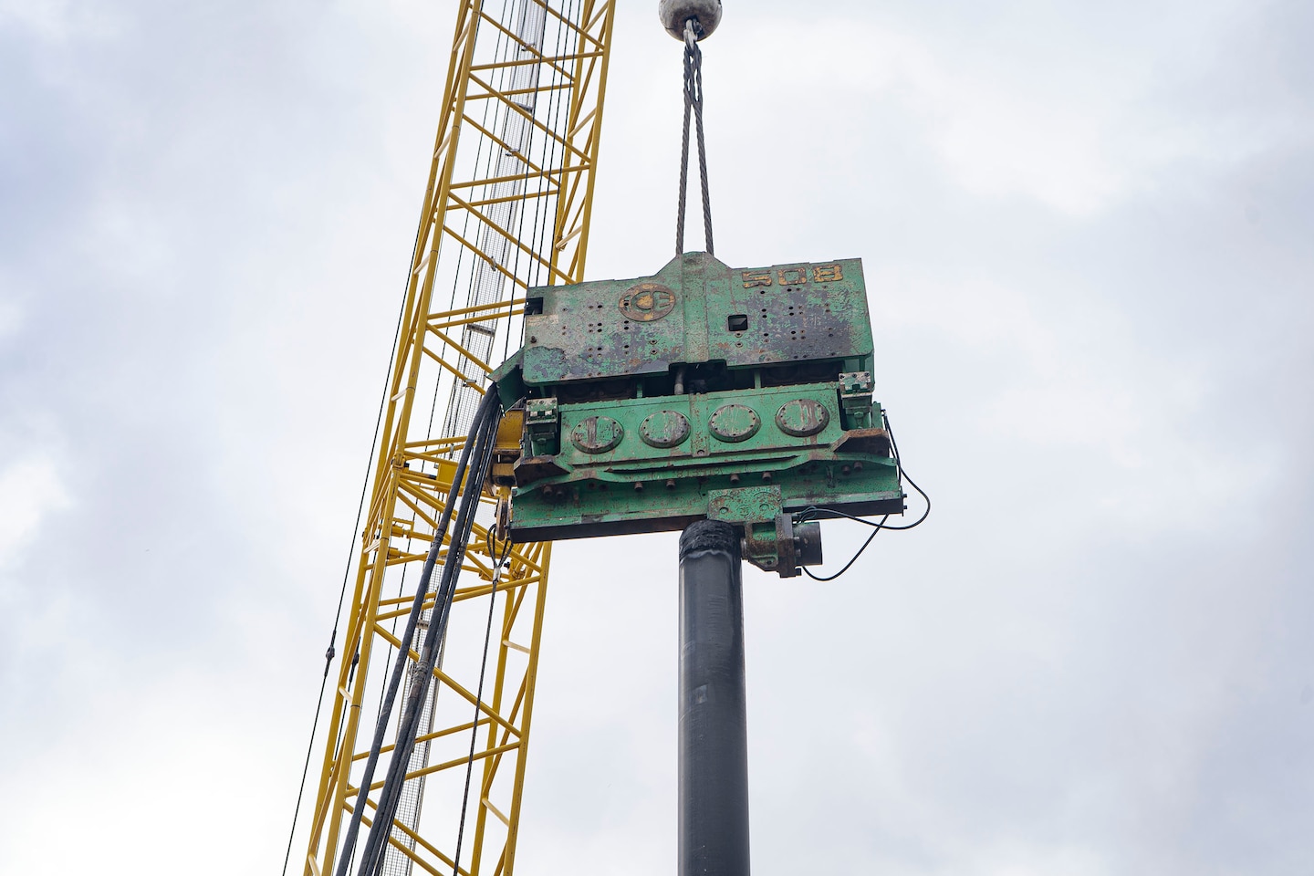 A crane mounts a hydraulic vibration hammer onto a steel piling that will make way for a new berthing slip to accommodate the newly arriving NACOTCHTANK Floating Crane alongside the Anacostia River in the District of Columbia, Jan. 18, 2022. The U.S. Army Corps of Engineers, Baltimore District’s,  DC Drift field office manages the Drift Program’s debris removal efforts, whose area of operation spans 27 miles long with an area of approximately 16 square miles. USACE boat operators conduct routine debris patrols and respond to debris calls received from the U.S. Coast Guard, U.S. Navy, boat and marina operators, and private citizens. (U.S. Army photo by Greg Nash)