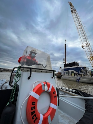 David Smith, U.S. Army Corps of Engineers, Baltimore District, crane operator, navigates past construction modifications of the District’s DC Drift field office docks alongside the Anacostia River on Jan 18, 2022. The docks will house the newly arriving NACOTCHTANK Floating Crane in the District of Columbia. The District’s DC Drift Program will continually protect environmental habitat, improve water quality and aesthetics, and expand public access within the Chesapeake Bay watershed. (U.S. Army photo by Greg Nash)