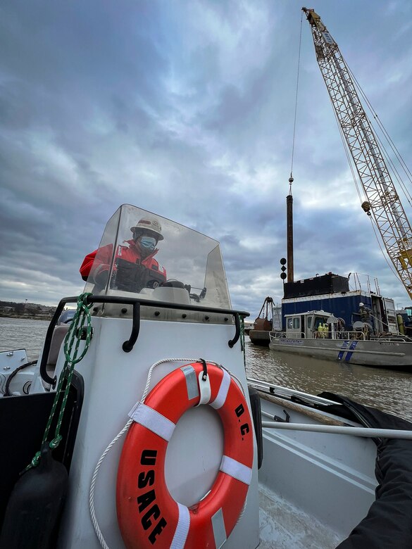 David Smith, U.S. Army Corps of Engineers, Baltimore District, crane operator, navigates past construction modifications of the District’s DC Drift field office docks alongside the Anacostia River on Jan 18, 2022. The docks will house the newly arriving NACOTCHTANK Floating Crane in the District of Columbia. The District’s DC Drift Program will continually protect environmental habitat, improve water quality and aesthetics, and expand public access within the Chesapeake Bay watershed. (U.S. Army photo by Greg Nash)