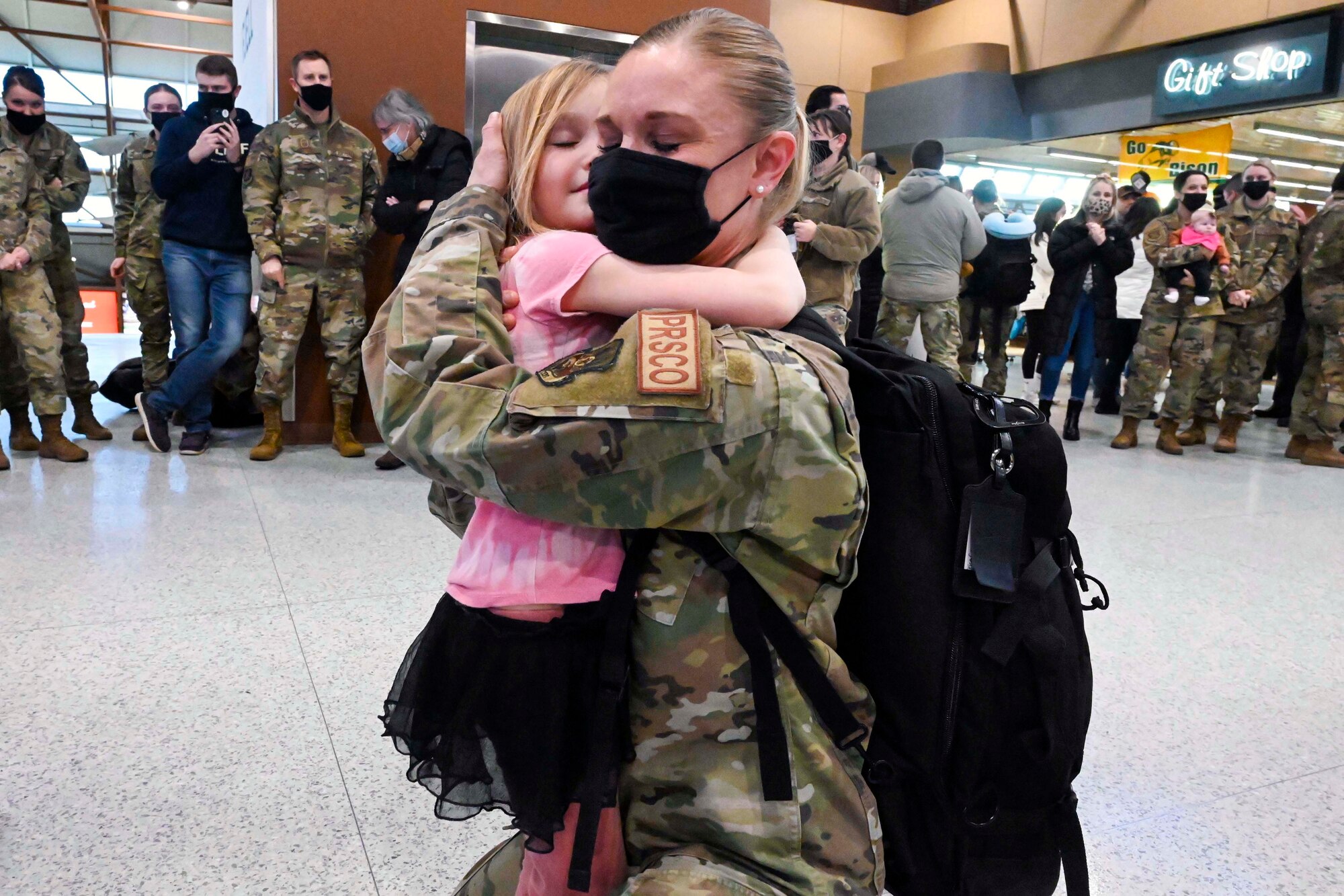 U.S. Air Force Senior Master Sgt. Erika Carruth, of the 119th Force Support Squadron, holds her daughter