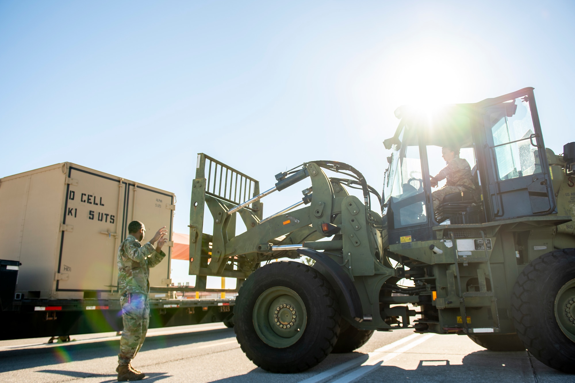 U.S. Air Force Tech. Sgt. Ismael Hayes, the noncommissioned officer in charge of Air Transportation for the 24th Special Operations Wing (SOW), Detachment 1, and Airman 1st Class Zoe Stough, a ground transportation support operator with the 6th Logistics Readiness Squadron, load cargo onto a semi-truck at MacDill Air Force Base, Florida, Feb. 1, 2022.