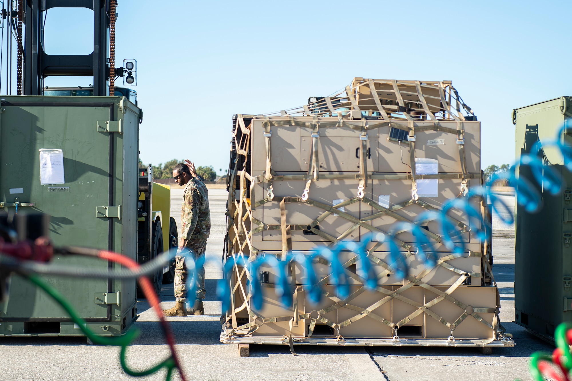 U.S. Air Force Tech. Sgt. Ismael Hayes the noncommissioned officer in charge of Air Transportation for the 24th Special Operations Wing, Detachment 1, helps load cargo at MacDill Air Force Base, Florida, Feb. 1, 2022.