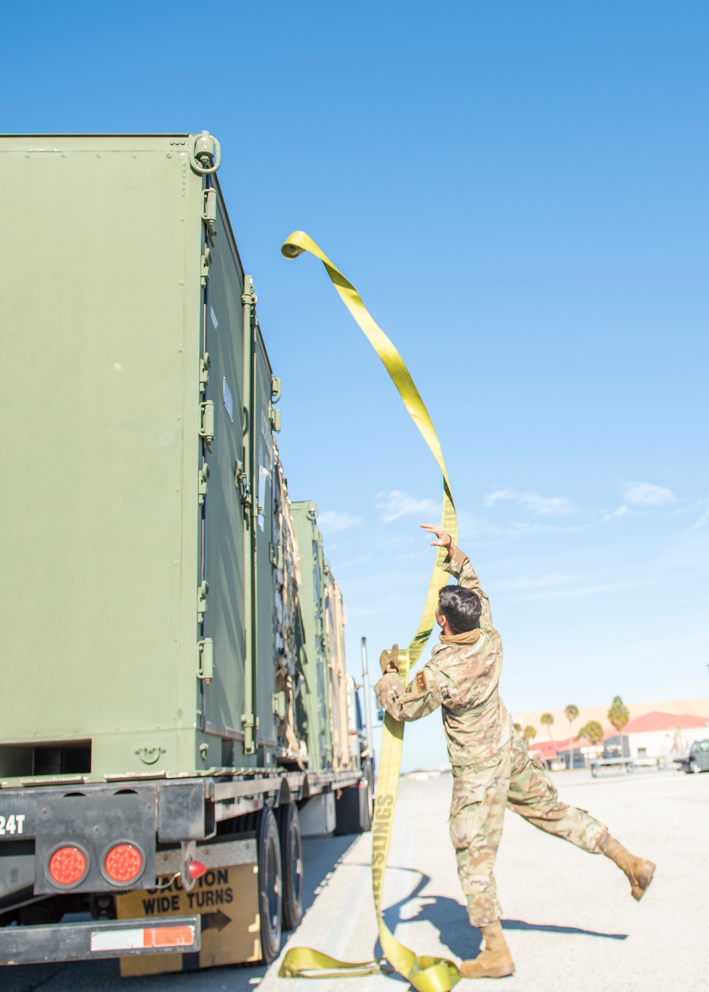 U.S. Air Force Airman 1st Class Felix Alvarez, a 6th Logistics Readiness Squadron (LRS) dispatch operator, tosses a cargo rope during a joint deployment exercise at MacDill Air Force Base, Florida, Feb. 1, 2022.