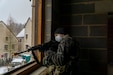 Sgt. Brandon Rupe, 2nd Platoon, 3rd Squad Leader from 444th Medical Company Ground Ambulance Unit, secures a building in MOUT site Ubensdorf Jan. 30, during Allied Spirit '22 at Hohenfels Training Area, Germany. Approximately 5,200 soldiers from 15 nations including Germany, Hungary, Italy, Kosovo, Latvia, Lithuania, Netherlands, Moldova, Poland, Portugal, Slovenia, Spain, Turkey, the United Kingdom, and the United States are participating in the exercising from Jan. 21 to Feb. 5, 2022. (U.S. Army photo by Karen Sampson)