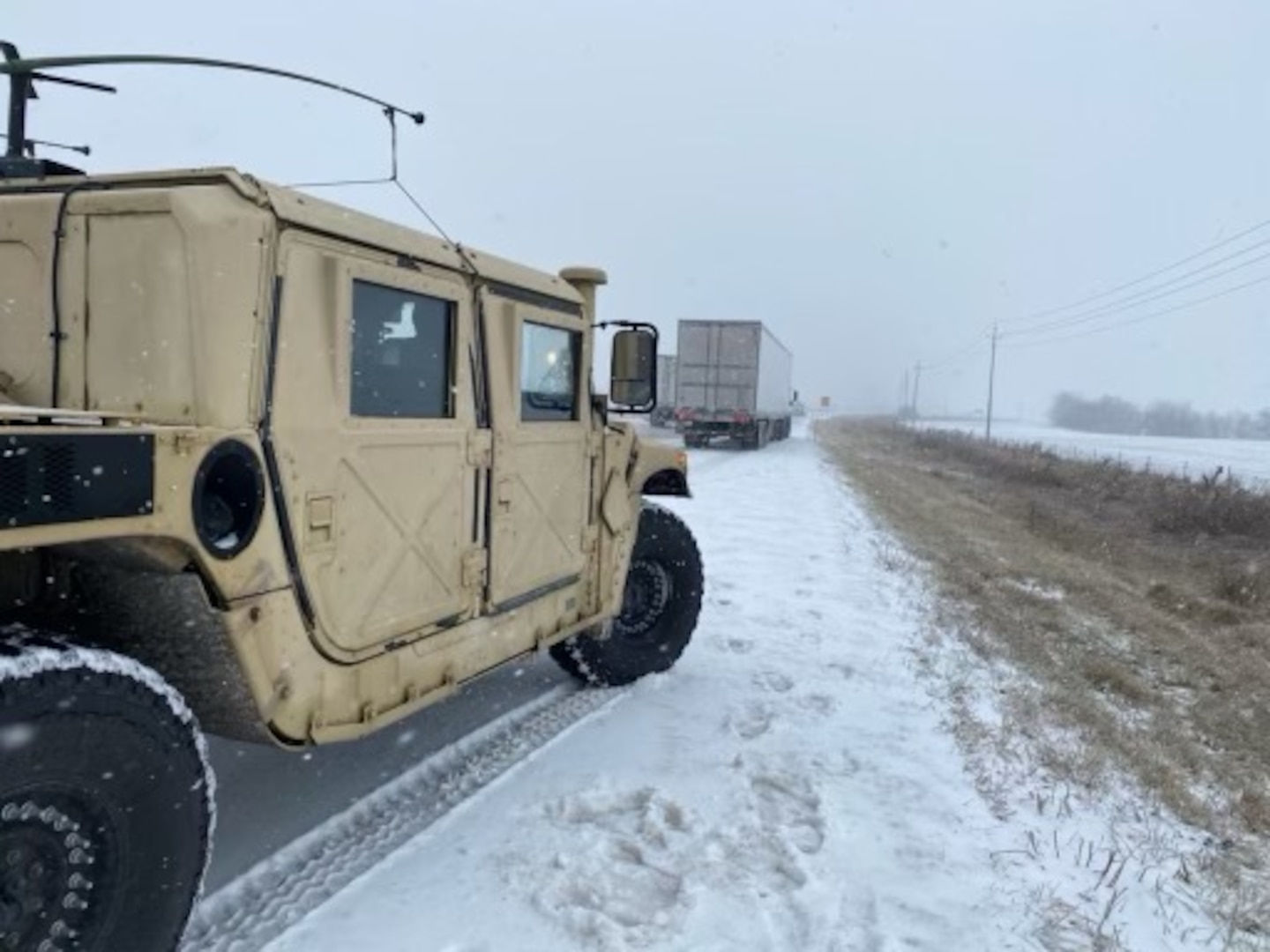 Indiana Guardsmen from the 38th Combat Aviation Brigade pull their Humvee over in order to assist a semitrailer that slid off the road due to severe winter weather conditions, Thursday, Feb. 3, 2022. A total of 60 highway teams assisted along Hoosier highways with 20 in the northern part of the state, 20 in the central and 14 in the south, with an additional six ready to move to areas of the state with extreme weather impacts.
