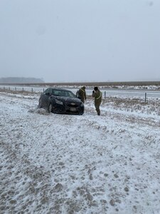Two Indiana National Guard soldiers assist a driver who slid off the road due to severe winter weather conditions, Thursday, Feb. 3, 2022. A total of 60 highway teams assisted along Hoosier highways with 20 in the northern part of the state, 20 in the central and 14 in the south, with an additional six ready to move to areas of the state with extreme weather impacts.