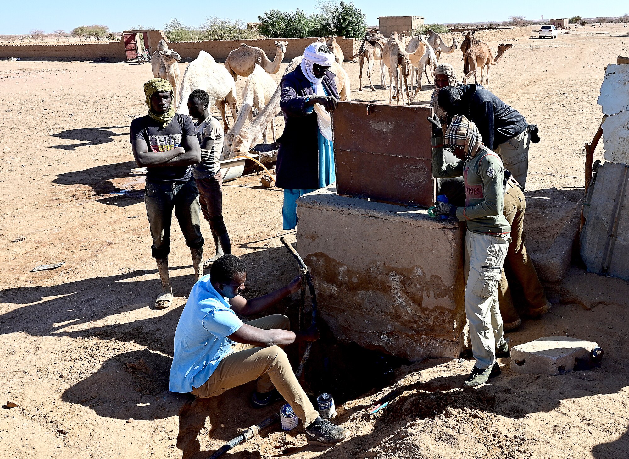 Members from the 404th Civil Affairs Battalion  team, 724th Expeditionary Air Base Squadron civil engineering flight, and the Nigerien Armed Forces (French language: Forces Armées Nigeriennes) action civil military (ACM) team repair a high-pressure waterline for the village of Alwat, Agadez, Niger, Jan. 22, 2022. The waterline provides clean water for the village and affirms U.S commitment to building partnership in Niger. (U.S. Air Force photo by Tech. Sgt. Stephanie Longoria)