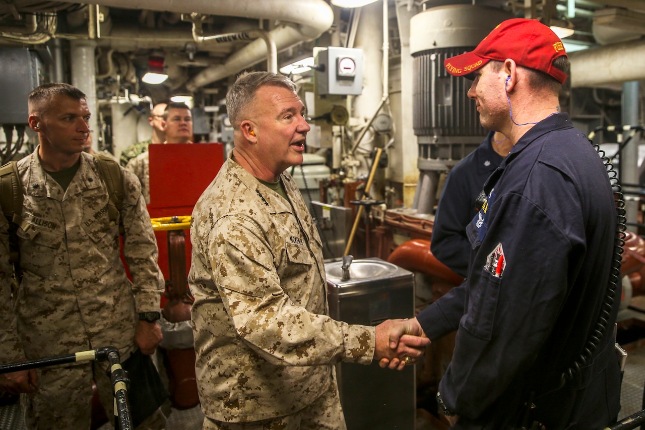 Marine Corps Gen. Kenneth McKenzie Jr. greets a sailor.