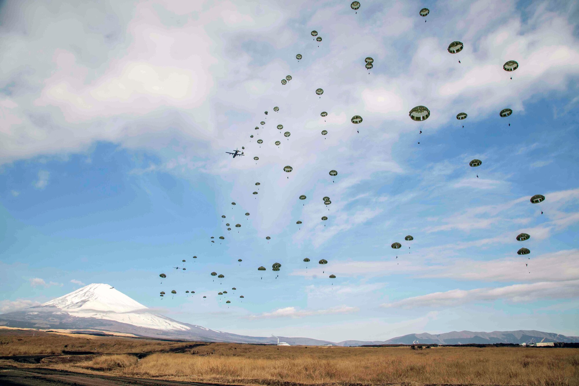 Japan Ground Self-Defense Force paratroopers assigned to the 1st Airborne Brigade descend from a U.S. Air Force C-130J