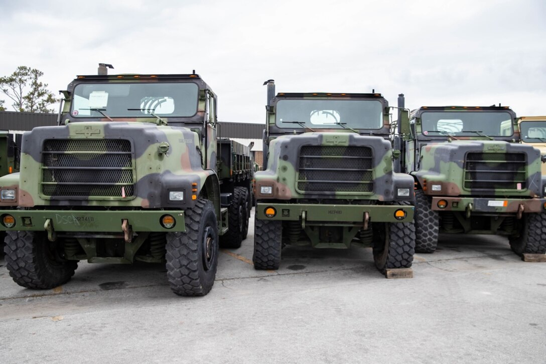 U.S. Marine Corps Medium Tactical Vehicle Replacements (MTVR) are staged in a line after receiving the installation of data loggers affiliated with the Condition-Based Maintenance Plus (CBM+) program on Camp Lejeune, North Carolina, Feb. 2, 2022. CBM+ is a maintenance and supply strategy that integrates process improvement, failure data, and technology to influence maintenance actions, increase equipment availability, and improve fleet management. 2nd Transportation Battalion is the first unit in the Fleet Marine Force to install data loggers affiliated with CBM+. (U.S. Marine Corps photo by Lance Cpl. Jessica J. Mazzamuto)