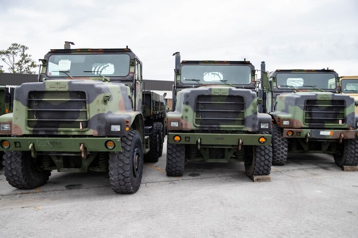 U.S. Marine Corps Medium Tactical Vehicle Replacements (MTVR) are staged in a line after receiving the installation of data loggers affiliated with the Condition-Based Maintenance Plus (CBM+) program on Camp Lejeune, North Carolina, Feb. 2, 2022. CBM+ is a maintenance and supply strategy that integrates process improvement, failure data, and technology to influence maintenance actions, increase equipment availability, and improve fleet management. 2nd Transportation Battalion is the first unit in the Fleet Marine Force to install data loggers affiliated with CBM+. (U.S. Marine Corps photo by Lance Cpl. Jessica J. Mazzamuto)