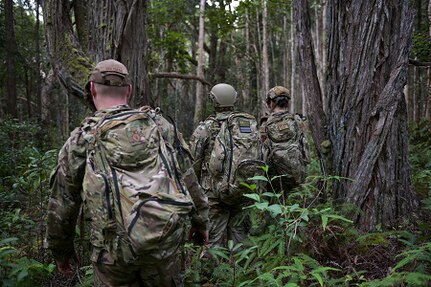 Wisconsin National Guard Airmen assigned to the Air National Guard's 115th Fighter Wing Security Forces Squadron in traverse a tropical rainforest near Wahiawa, Hawaii, Jan. 14, 2022. The navigation exercise was part of a two-week jungle and ocean survival training course.