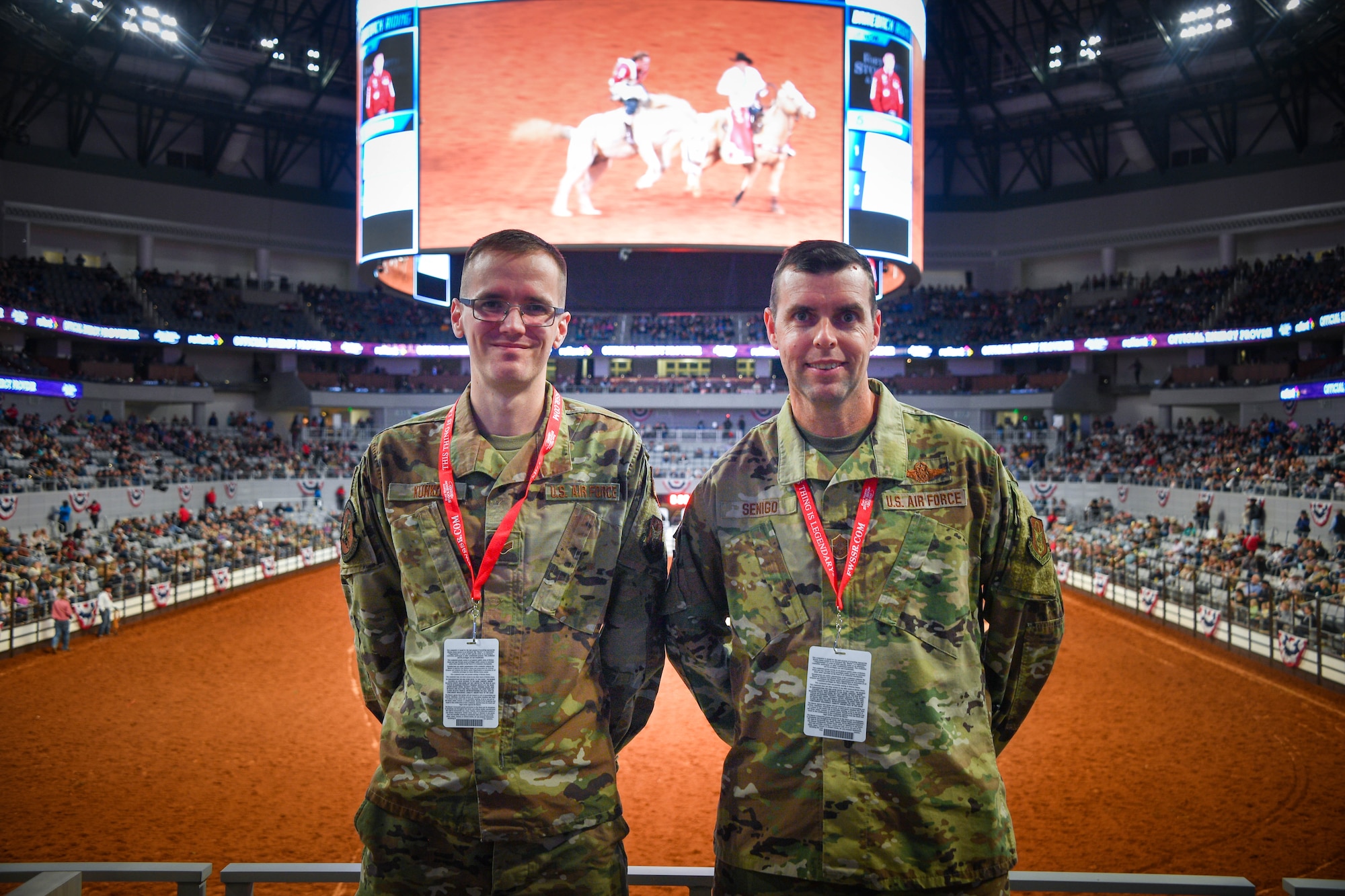 Senior Airman Matthew Kunkos, 301st Logistics Readiness Squadron fuels specialist (left) and Chief Master Sgt. Michael S. Senigo 301 FW command chief, pose for photo at Dickie’s Arena on Jan. 31, 2022. The 301 FW has been honored to ride in the procession of Military Appreciation Day since 2012.(U.S. Air Force photo by Staff Sgt. Nije Hightower)