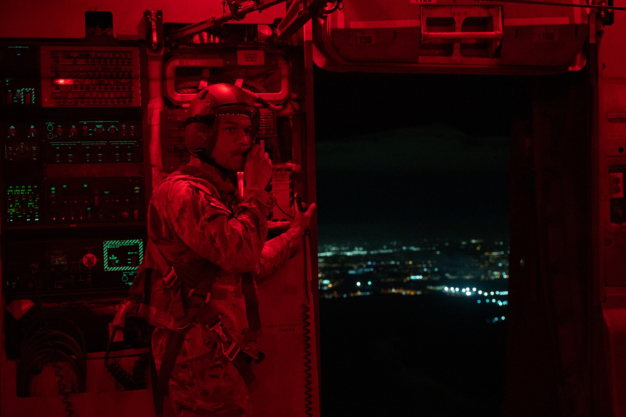 U.S. Air Force Senior Airman Brandon Vasey, a loadmaster with the 7th Airlift Squadron, prepares U.S. Army paratroopers to exit      a C-17 Globemaster III during Battalion Mass Tactical Week at Pope Army Airfield, North Carolina, Feb. 3, 2022. BMTW is a joint exercise between the U.S. Air Force and U.S. Army to enhance members’ abilities by practicing scenarios in a controlled environment. (U.S. Air Force photo by Airman 1st Class Charles Casner)