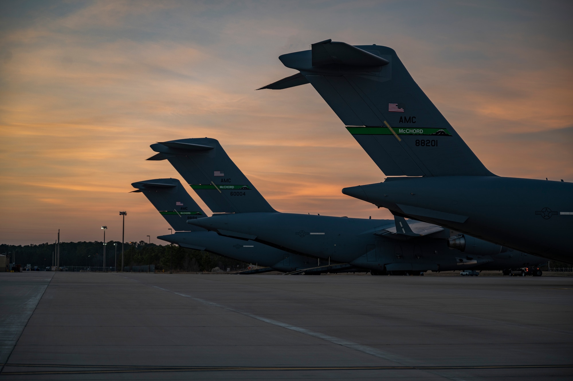 Three C-17 Globemaster IIIs assigned to Joint Base Lewis-McChord, Washington, sit on a flightline at Pope Army Airfield, North Carolina, Jan. 31, 2022. The C-17 aircrew are conducting operations for Battalion Mass Tactical Week, which is a joint exercise designed to enhance participants’ abilities by practicing scenarios in a controlled environment. (U.S. Air Force photo by Airman 1st Class Charles Casner)