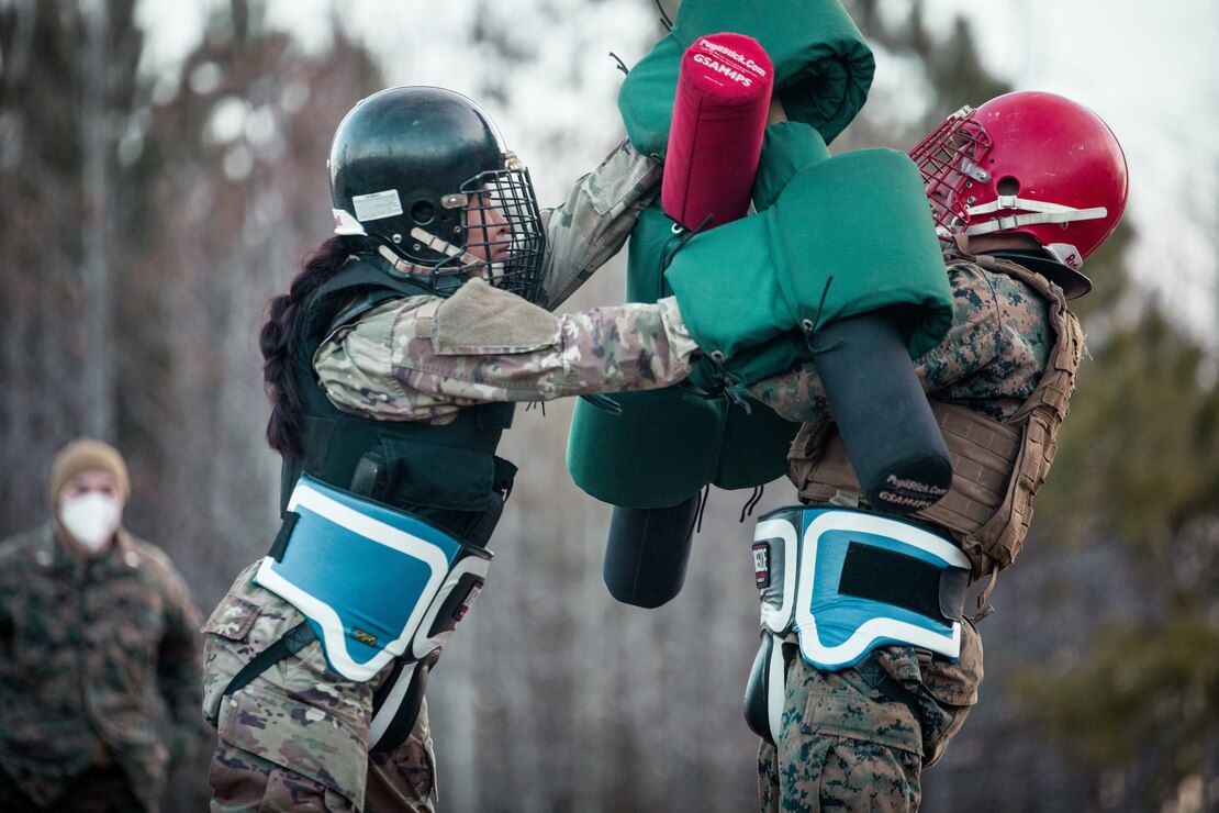 U.S. Army Spc. Hannah Benally, a unit supply specialist with 919 Military Police Company, Task Force Pickett, from Shiprock, New Mexico, performs a high-block technique during a Marine Corps Martial Arts Program sparring match at Fort Pickett, Va., Jan. 28, 2022. MCMAP sparring matches are used for Marines to practice executing techniques, learned during MCMAP classes, in a simulated close-quarters combat environment.
