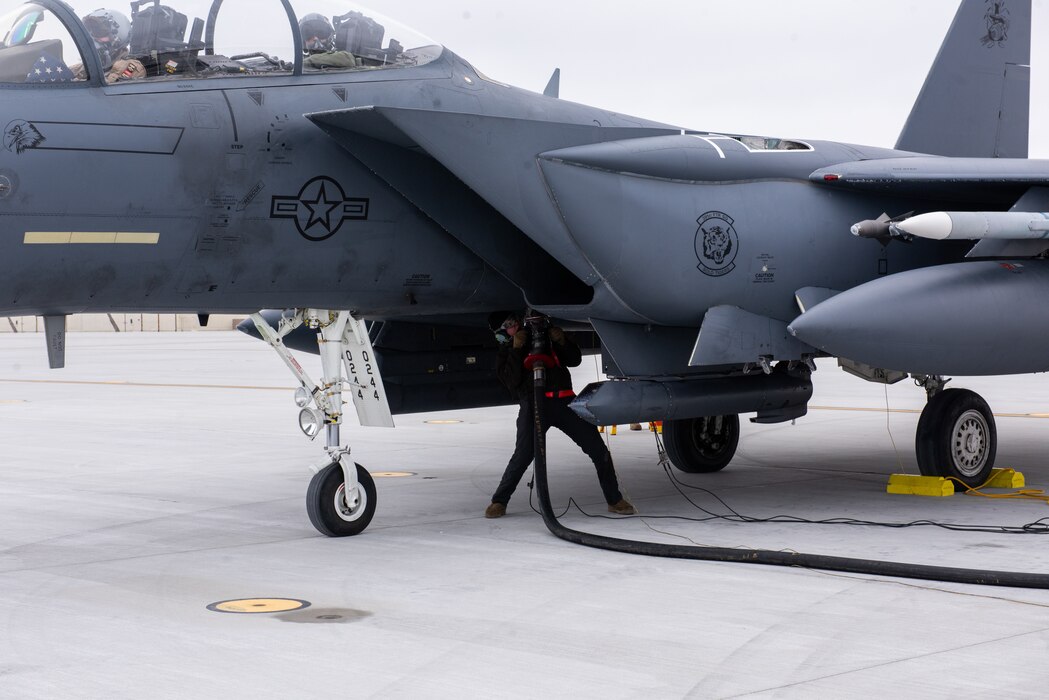 U.S. Air Force Senior Airman Cole Cash, 391st Fighter Generation Squadron avionics journeyman, refuels an F-15E Strike Eagle during a Multi-Capable Airman training at Mountain Home AFB, Idaho, Jan. 25, 2022. The multi-capable Airman training provides Airmen a chance to expand skills in support of the Agile Combat Employment concept. (U.S. Air Force photo by Staff Sgt. Joshua Hoskins)