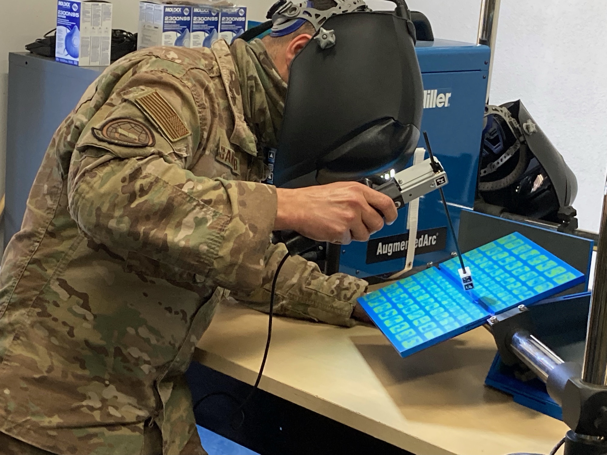 Airman uses SMAW welding methods with augmented reality.