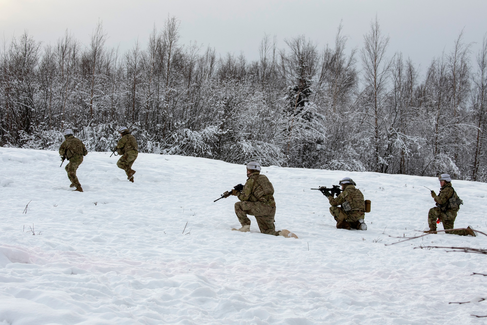 U.S. Army paratroopers assigned to A Troop, 1st Squadron (Airborne), 40th Cavalry Regiment, 4th Infantry Brigade Combat Team (Airborne), 25th Infantry Division, U.S. Army Alaska, assault a simulated enemy position on the Light Infantry Collective Training Course at Joint Base Elmendorf-Richardson, Alaska, Feb. 2, 2022. Cavalry scouts conducted live-fire maneuver training which focused on eliminating simulated enemy positions through fire team movement. USARAK trains year-round to increase lethal combat support in an arctic environment.