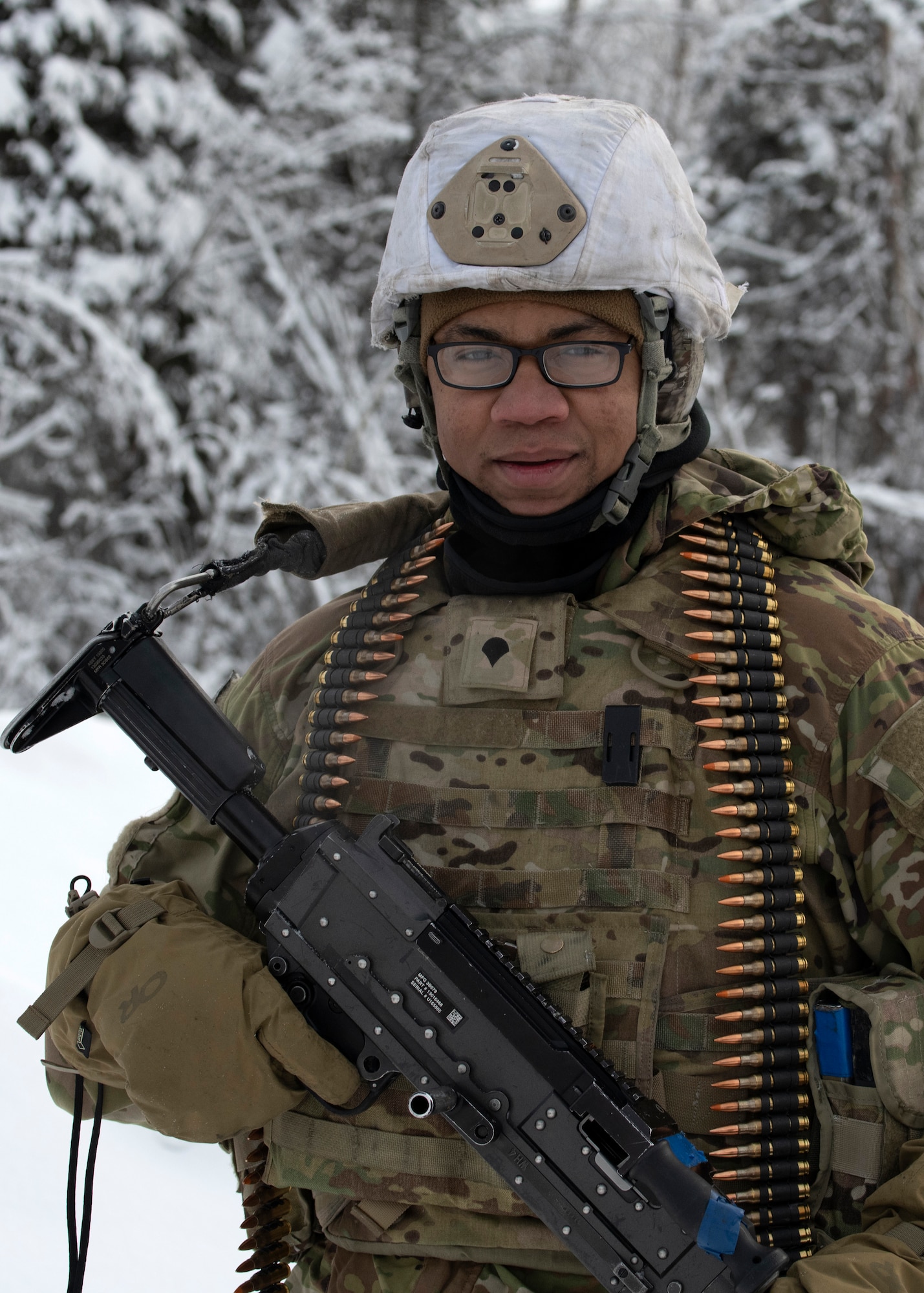 U.S. Army Spc. Frank Johnson, a cavalry scout assigned to A Troop, 1st Squadron (Airborne), 40th Cavalry Regiment, 4th Infantry Brigade Combat Team (Airborne), 25th Infantry Division, U.S. Army Alaska, poses for a photograph on the Light Infantry Collective Training Course at Joint Base Elmendorf-Richardson, Alaska, Feb. 2, 2022. Cavalry scouts conducted live-fire maneuver training which focused on eliminating simulated enemy positions through fire team movement. USARAK trains year-round to increase lethal combat support in an arctic environment.