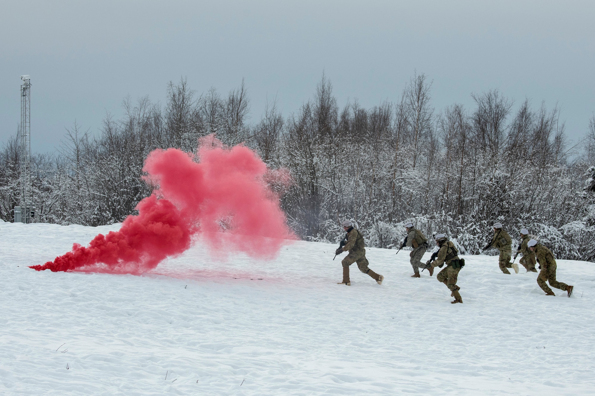 U.S. Army paratroopers assigned to A Troop, 1st Squadron (Airborne), 40th Cavalry Regiment, 4th Infantry Brigade Combat Team (Airborne), 25th Infantry Division, U.S. Army Alaska, assault a simulated enemy position on the Light Infantry Collective Training Course at Joint Base Elmendorf-Richardson, Alaska, Feb. 2, 2022. Cavalry scouts conducted live-fire maneuver training which focused on eliminating simulated enemy positions through fire team movement. USARAK trains year-round to increase lethal combat support in an arctic environment.