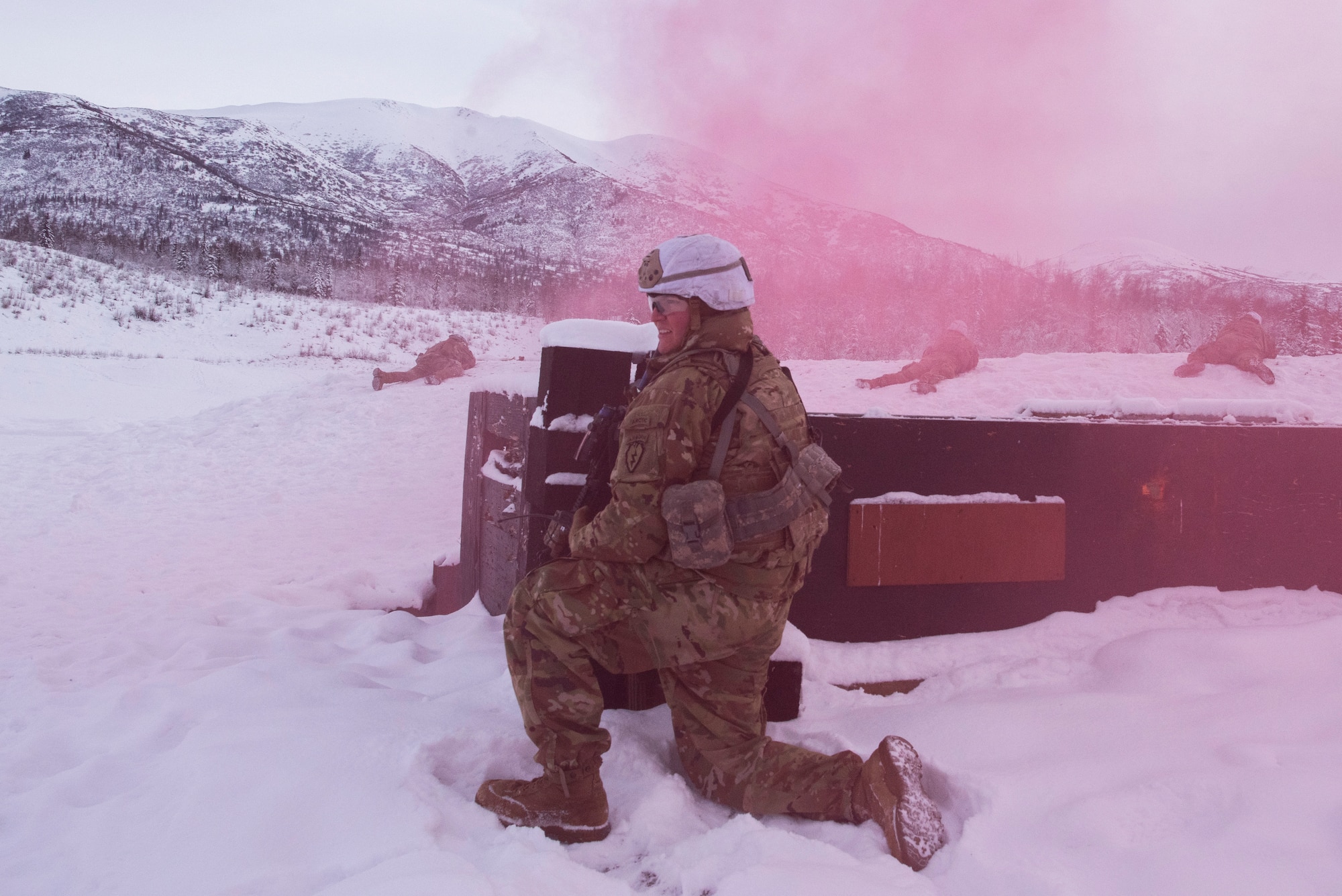 U.S. Army Sgt. Brandon Taylor, a fire team leader assigned to A Troop, 1st Squadron (Airborne), 40th Cavalry Regiment, 4th Infantry Brigade Combat Team (Airborne), 25th Infantry Division, U.S. Army Alaska, holds his position while his team engages a simulated enemy position on the Light Infantry Collective Training Course at Joint Base Elmendorf-Richardson, Alaska, Feb. 2, 2022. Cavalry scouts conducted live-fire maneuver training which focused on eliminating simulated enemy positions through fire team movement. USARAK trains year-round to increase lethal combat support in an Arctic environment.