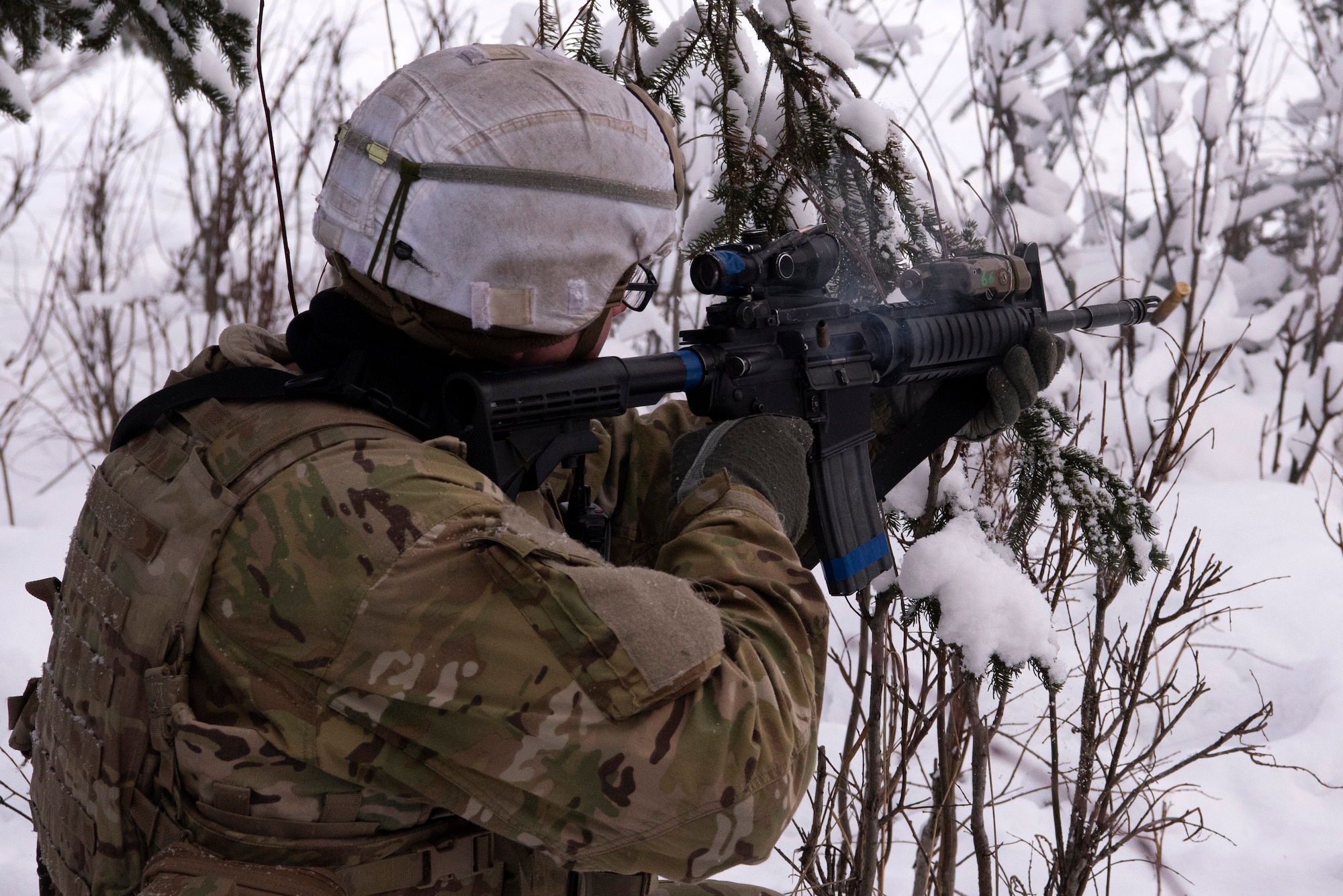 A U.S. Army paratrooper assigned to A Troop, 1st Squadron (Airborne), 40th Cavalry Regiment, 4th Infantry Brigade Combat Team (Airborne), 25th Infantry Division, U.S. Army Alaska, engages a simulated enemy position on the Light Infantry Collective Training Course at Joint Base Elmendorf-Richardson, Alaska, Feb. 2, 2022. Cavalry scouts conducted live-fire maneuver training which focused on eliminating simulated enemy positions through fire team movement. USARAK trains year-round to increase lethal combat support in an arctic environment.