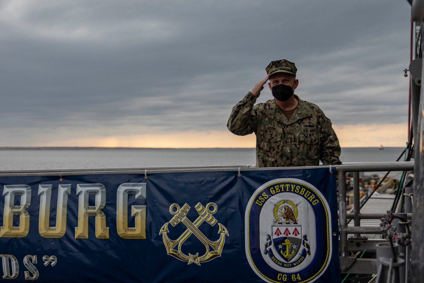 CNO Gilday salutes on the bridge of the USS Gettysburg