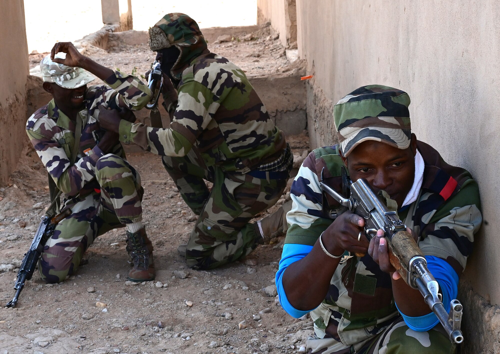 Three Nigerien Armed Forces (French language: Forces Armées Nigeriennes) members, practice combat lifesaving skills taught to them by the 409th Expeditionary Security Forces Squadron air advisors and 724th Expeditionary Air Base Squadron firefighters at Nigerien Air Base 201, Agadez, Niger, Jan. 21, 2022. The 409th ESFS hosted an eight-week course to train the FAN on various tactics such as combat lifesaving skills, weapon maneuvers, vehicle searches and patrol movements to enhance their ability to counter escalating violent extremism in the tri-border region of Niger, Burkina Faso, and Mali. (U.S. Air Force photo by Tech. Sgt. Stephanie Longoria)