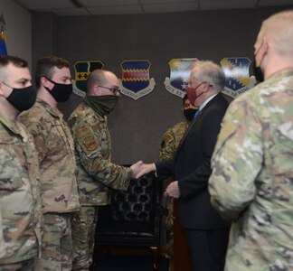 Secretary of the Air Force Frank Kendall coins several 16th Air Force (Air Forces Cyber) Airmen for excellence during his visit to Joint Base San Antonio-Lackland, Texas, Feb. 2, 2022.
