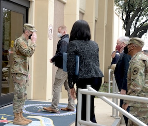 Secretary of the Air Force Frank Kendall and Air Force Chief of Staff Gen. CQ Brown, Jr., are greeted by Brig. Gen. Bradley L. Pyburn, 16th Air Force (Air Forces Cyber) deputy commander, at Joint Base San Antonio-Lackland, Texas, Feb. 2, 2022