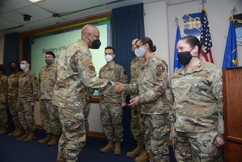 Air Force Chief of Staff Gen. CQ Brown, Jr., coins several 16th Air Force (Air Forces Cyber) Airmen during his visit to Joint Base San Antonio-Lackland, Texas, Feb. 2, 2022.