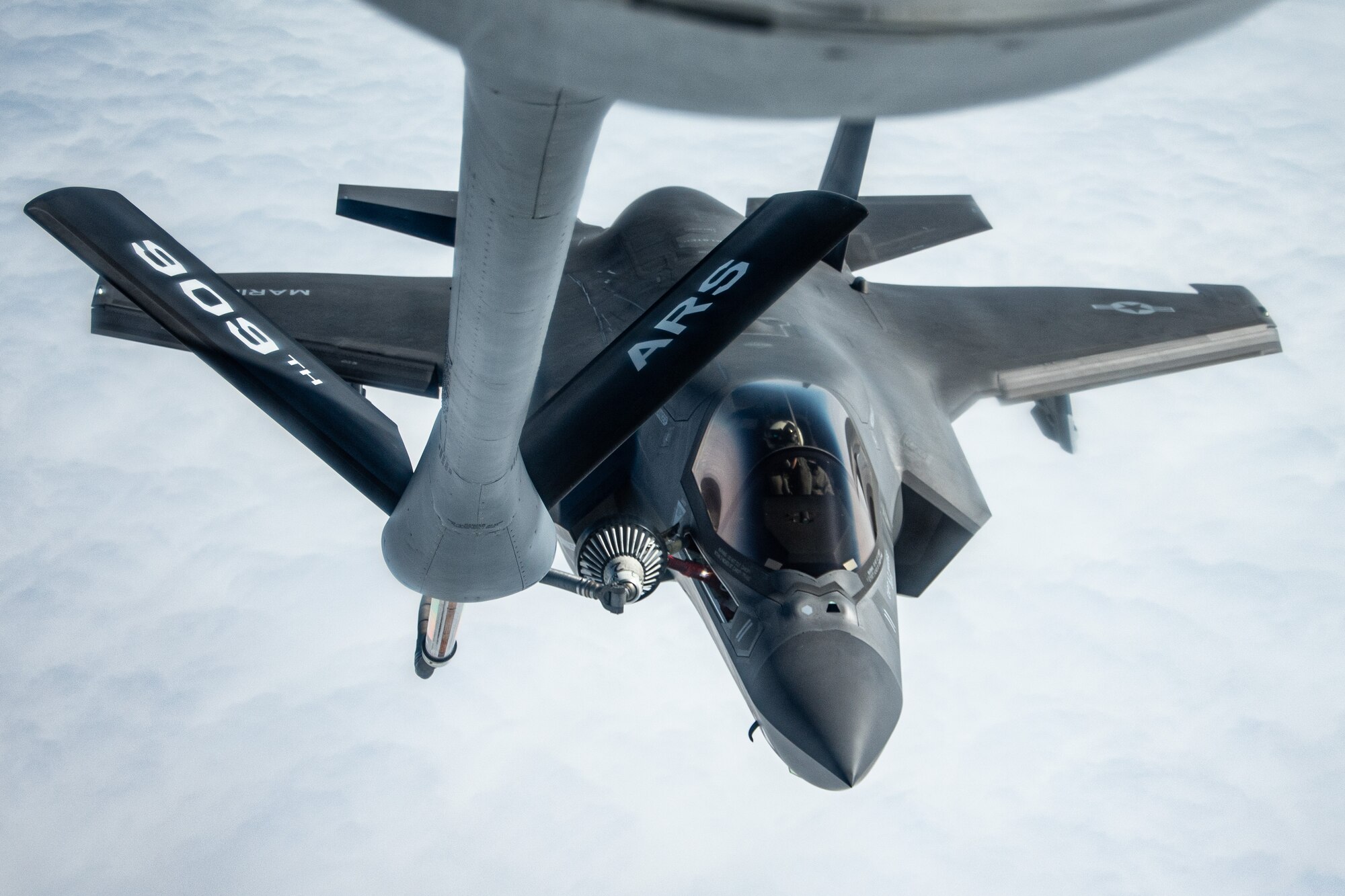 A fighter jet gets refueled