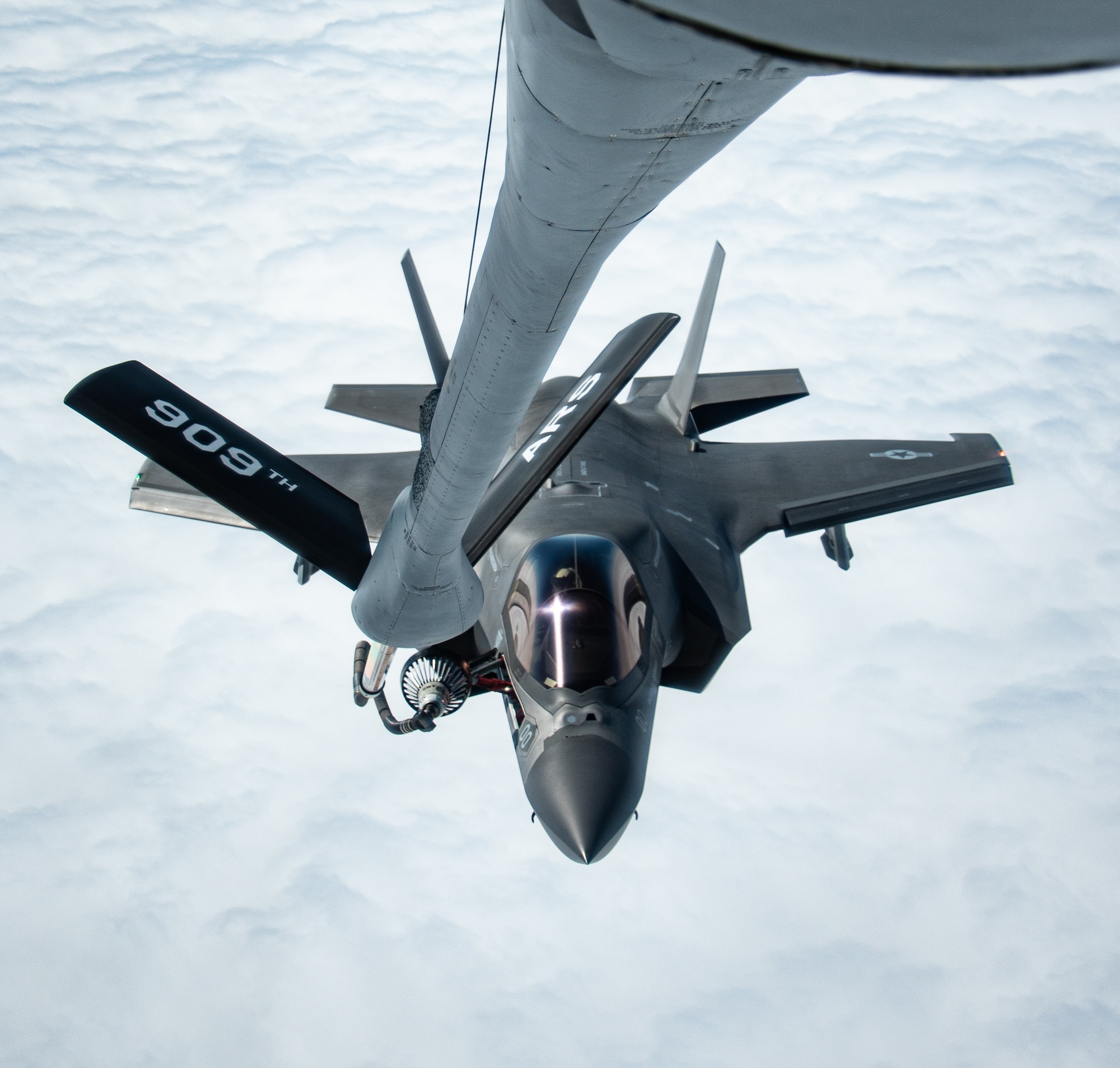 A fighter jet gets refueled