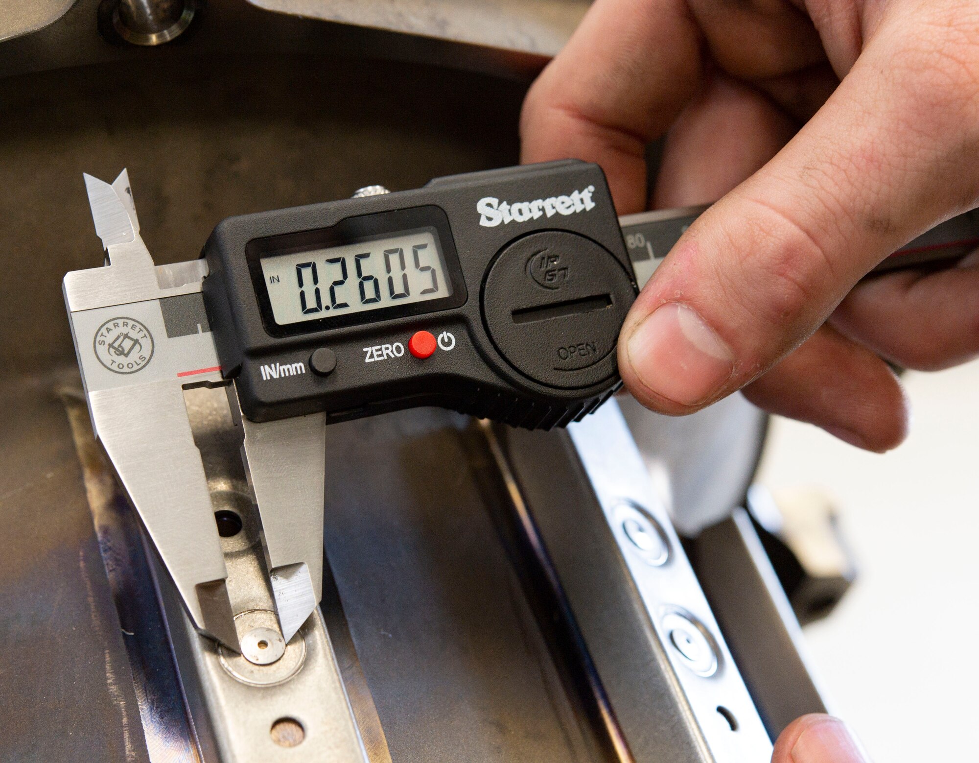 Senior Airman Weston Rose, 436th Maintenance Squadron aircraft hydraulics technician, uses a digital micrometer to measure the diameter of a newly installed rivet on a C-5M Super Galaxy brake torque tube assembly at Dover Air Force Base, Delaware, Nov. 10, 2021. An orbital riveter assists hydraulic shop personnel in repairing C-5M brake assemblies locally and return them into the supply inventory in minimal time, eliminating the need to outsource repairs. (U.S. Air Force photo by Roland Balik)