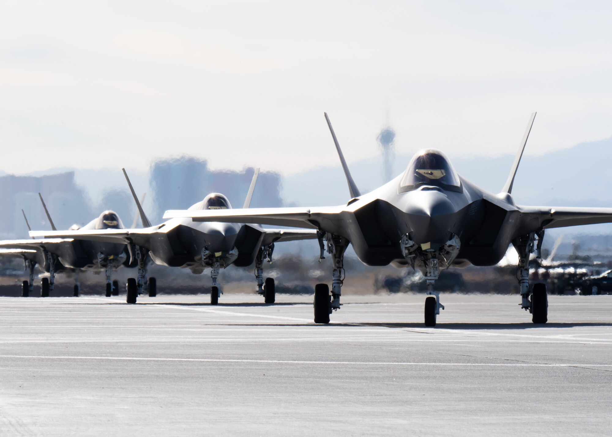 a photo of F-35As taxiing down the runwa