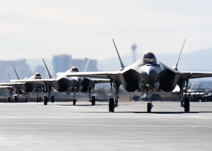a photo of F-35As taxiing down the runwa