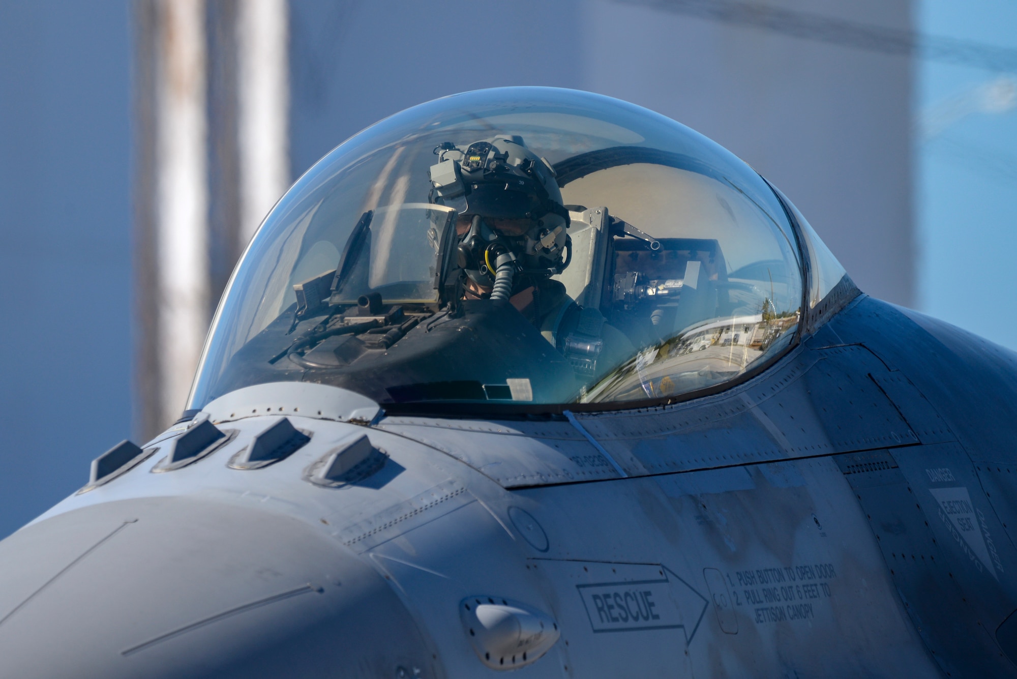 An image of an F-16 fighter pilot preparing to taxi