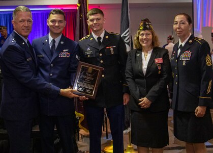 Maj. Gen. Rich Neely, left, of Springfield, the Adjutant General of Illinois and Commander of the Illinois National Guard, Senior Airman Cole Gelfius, of Dahlgren, second from left, Airman of the Year of the Illinois Air National Guard, Spc. Avery Caraker, of DuQuoin, center, Warrior of the Year of the Illinois Army National Guard, and Command Sgt. Maj. Dena Ballowe, of Litchfield, Senior Enlisted Leader of the Illinois National Guard, accept the Department of Illinois Veterans of Foreign Wars 2021 Hometown Heroes of the Year Award from Illinois VFW State Commander Laurie Emmer, of Sycamore, at their 100th annual State Convention June 11 in Springfield, Illinois.