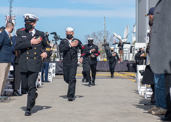 Sailors assigned to the Independence-variant littoral combat ship USS Savannah (LCS 28) run aboard to man Savannah as part of its commissioning ceremony.