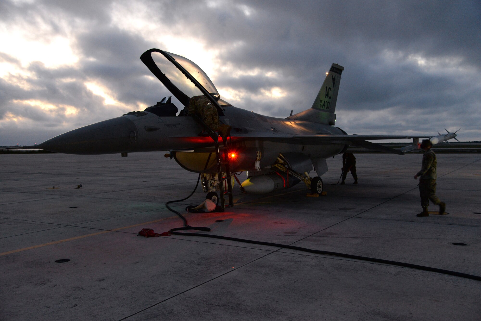 An image of U.S. Air Force crew chiefs, from the 177th Fighter Wing of the New Jersey Air National Guard, conduct F-16C fighter jet power-on checks