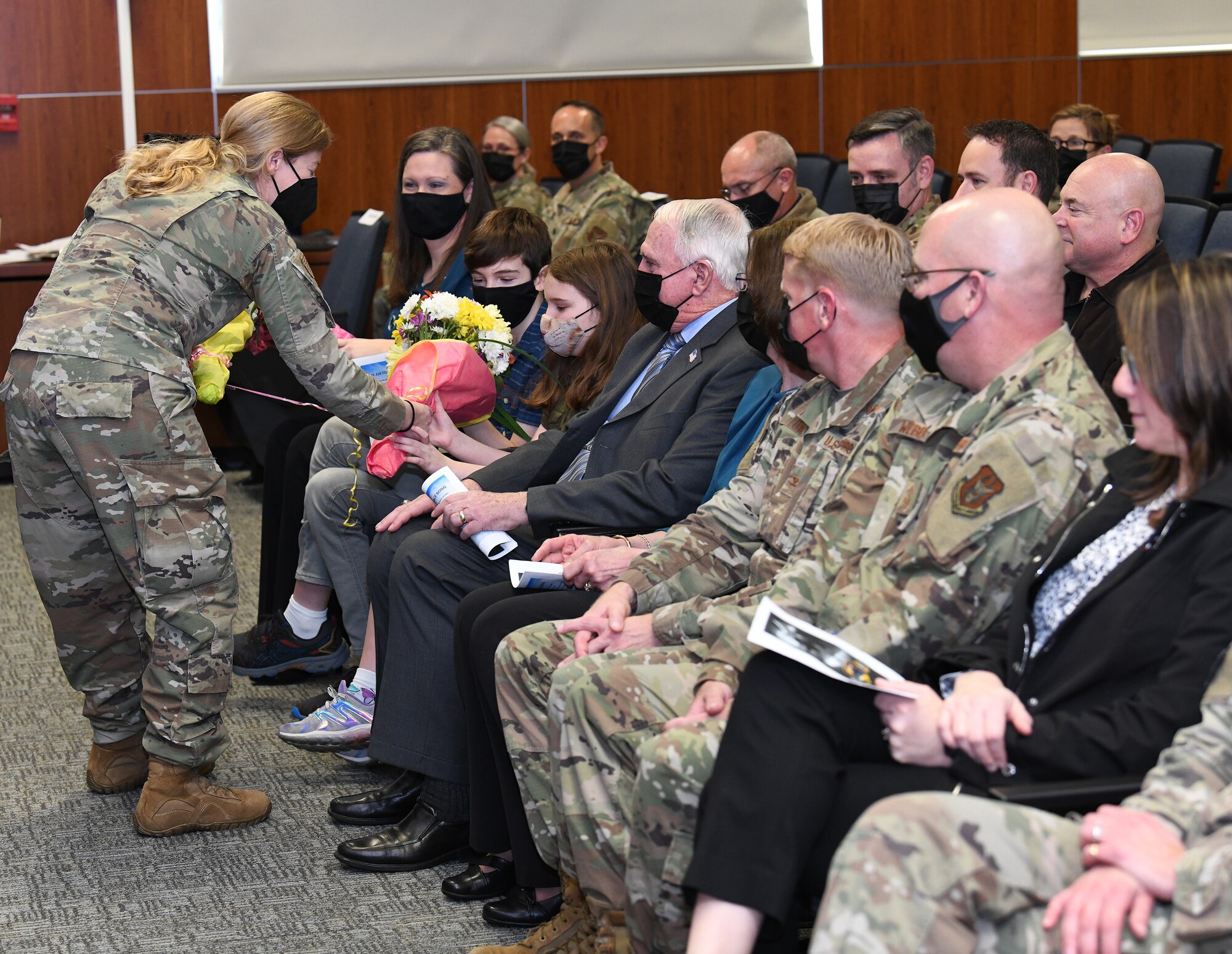 A bouquet of flowers is handed to Col. Matthew Barry's family.