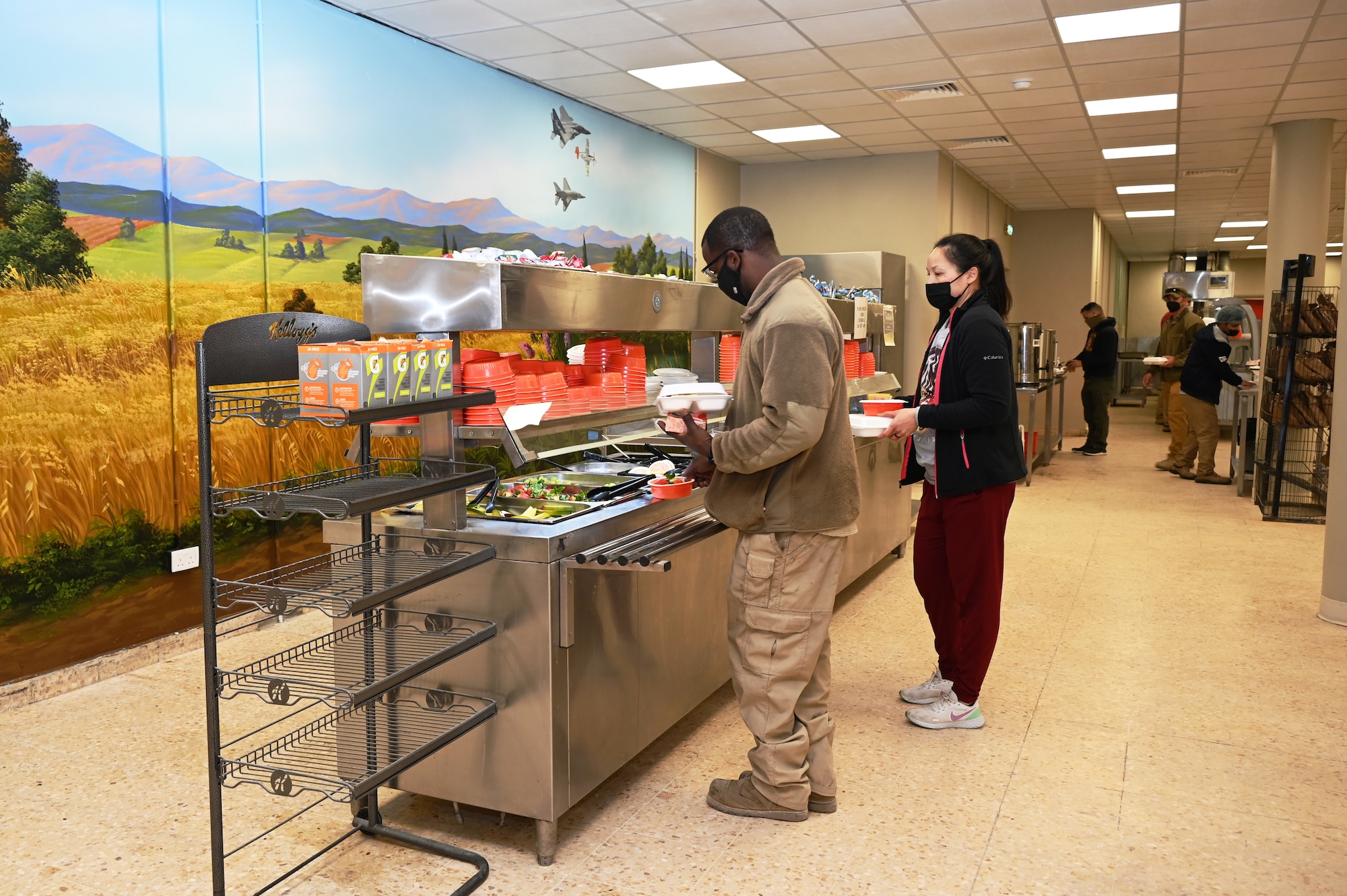 332d Air Expeditionary Wing Airmen select breakfast items in the Red Tails Dining Facility Feb., 7, 2022 in Southwest Asia. The 332d Expeditionary Force Support Squadron, in conjunction with the 332d Expeditionary Civil Engineer Squadron, just completed its dining facility multifaceted renovation project. (U.S Air Force photo by Tech. Sgt. Lauren M. Snyder)