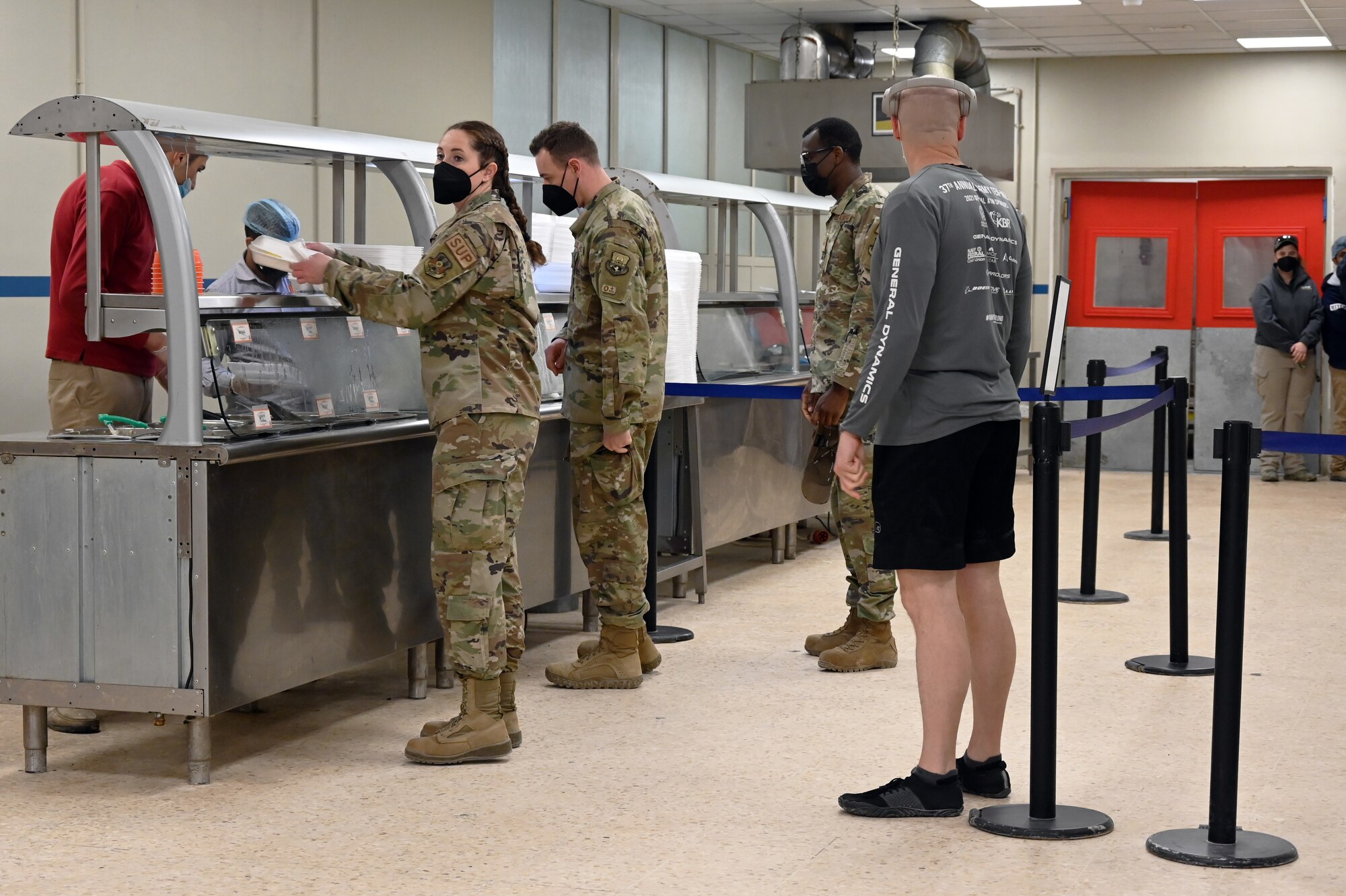 332d Air Expeditionary Wing Airmen queue up for hot breakfast items in the Red Tails Dining Facility Feb., 7, 2022 in Southwest Asia. The 332d Expeditionary Force Support Squadron, in conjunction with the 332d Expeditionary Civil Engineer Squadron, just completed its dining facility multifaceted renovation project. (U.S Air Force photo by Tech. Sgt. Lauren M. Snyder)