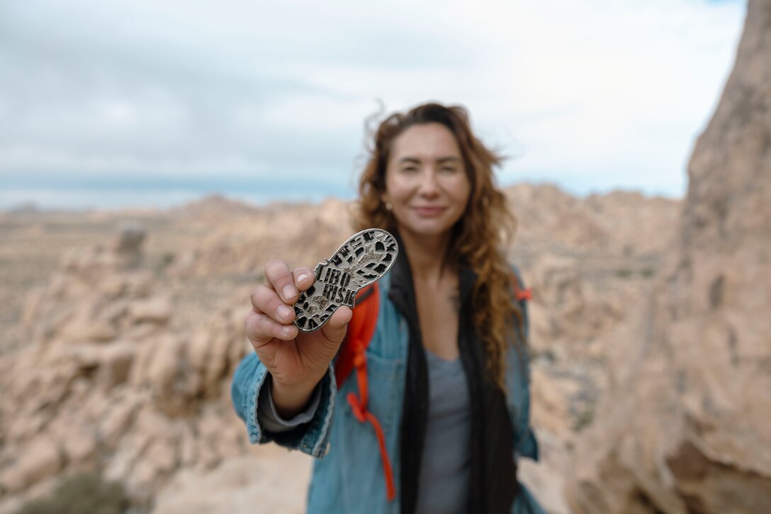 Jessica Quezada, a U.S. Marine Corps veteran, poses for a photo at Joshua Tree National Park, Joshua Tree, California during a LiboRisk event, Jan. 29, 2022. Quezada is the founder of LiboRisk, a travel community to bring active duty and veteran service members together to further build camaraderie outside the military and expose attendees to new, positive experiences. (U.S. Marine Corps photo by Staff Sgt. Kelsey Dornfeld)