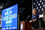 Commandant Karl Schultz stands at a podium in the operational dress uniform