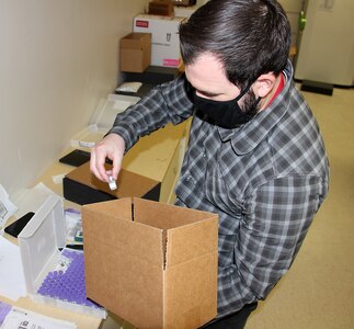 Brendan Harris, a logistics analyst for the U.S. Army Medical Materiel Agency’s Distribution Operations Center, or DOC, readies doses of COVID-19 vaccine for shipment Jan. 26 at Fort Detrick, Maryland. The DOC works closely with the Department of Health and Human Services and Defense Health Agency to distribute vaccines and COVID-19 therapeutics around the globe to protect the operational force.