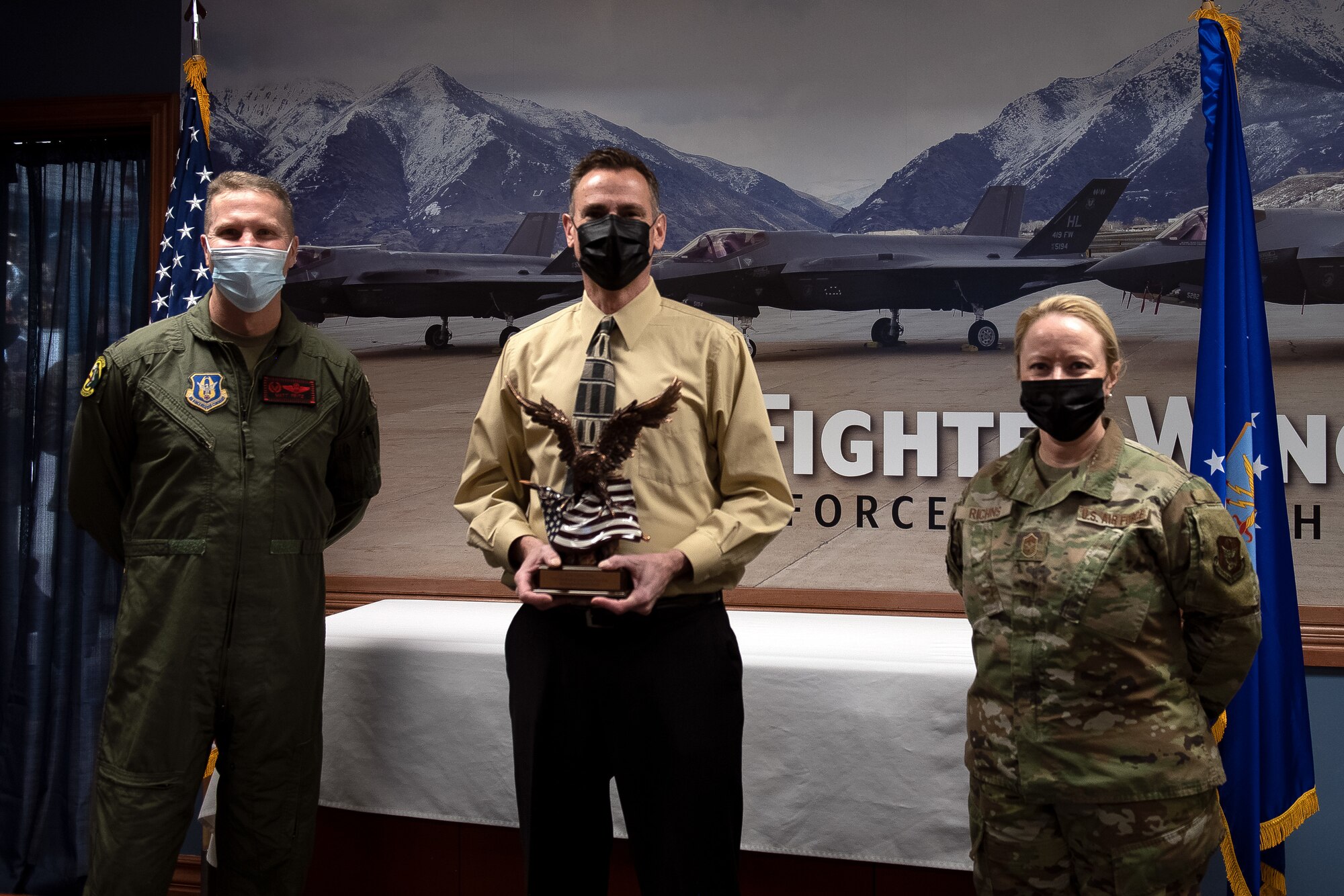 Col. Matthew Fritz, 419th Fighter Wing commander, and Chief Master Sgt. Heather Richins, 419th FW command chief, present the wing’s Employer of the Year award to Pastor Roy Gruber from Washington Heights Church during a ceremony Feb. 6, 2022 at Hill Air Force Base, Utah.